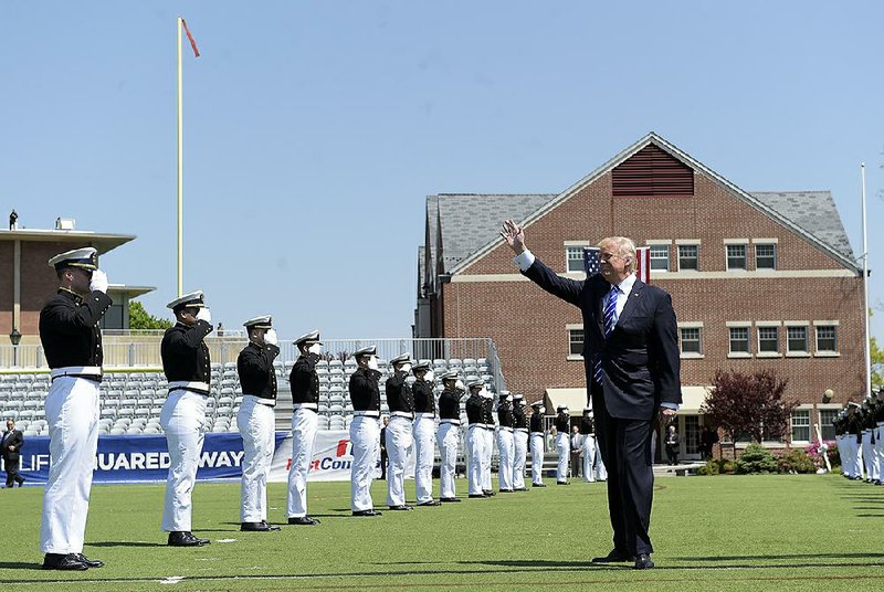 Graduates of the U.S. Coast Guard Academy in New London, Conn., salute President Donald Trump before his commencement address Wednesday. Trump, saying “no politician in history” has been treated worse than him, told the class that “the more righteous your fight, the more opposition that you will face.”