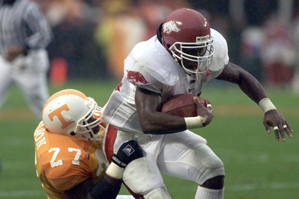 Arkansas running back Madre Hill (34) is tackled by Tennessee linebacker Al Wilson (27) during a game Saturday, Nov. 14, 1998, in Knoxville, Tenn. 