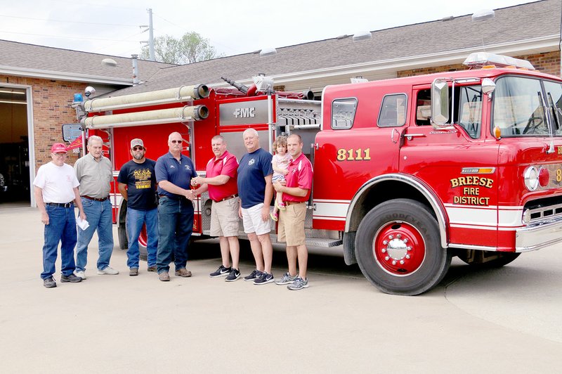 Photo courtesy of the Breese Journal Breese (Ill.) Fire Chief Bob Wuest presents the keys to the 1989 FMC rescue pumper to Goodman Fire Chief Keith Estes. Breese recently replaced the 1989 rescue pumper with a 2017 KME rescue pumper, which was put into service two weeks ago. Those on hand for the presention include, left: Bud Gilmore of the Goodman Fire Protection District Board; Andy Huelsmann of the Breese Fire Protection District Board; Goodman Fireman Kent Hartman, Goodman Fire Chief Keith Estes, Breese Fire Chief Bob Wuest, Breese fireman Curt Weh and fireman Ryan Weh holding his daughter Lena.