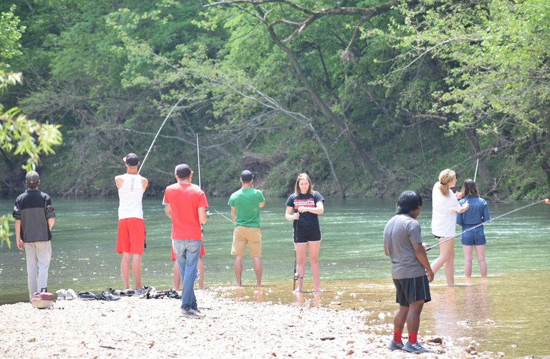 Lee Smith&#8217;s lifetime sports class at McDonald County High School learns proper fishing techniques during an outing on Indian Creek last week. The Missouri Department of Conservation provides a group permit and the equipment to make the class possible.