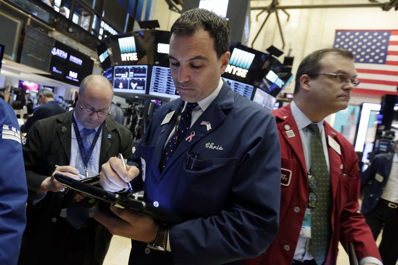Trader Christopher LaGana, center, works on the floor of the New York Stock Exchange, Wednesday, May 17, 2017. Stocks are opening lower on Wall Street as banks and industrial companies fall. (AP Photo/Richard Drew)