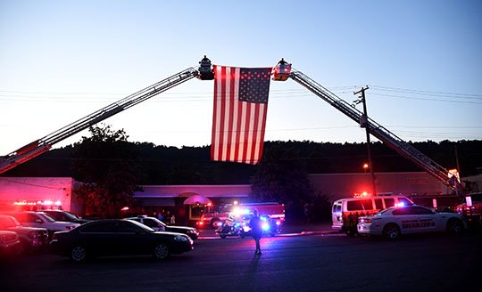 The Sentinel-Record/Mara Kuhn RED, WHITE AND BLUE: Firefighters and other emergency personnel pay tribute during the Fallen Officer Memorial Service at the Garland County Sheriff's Department Tuesday evening.
