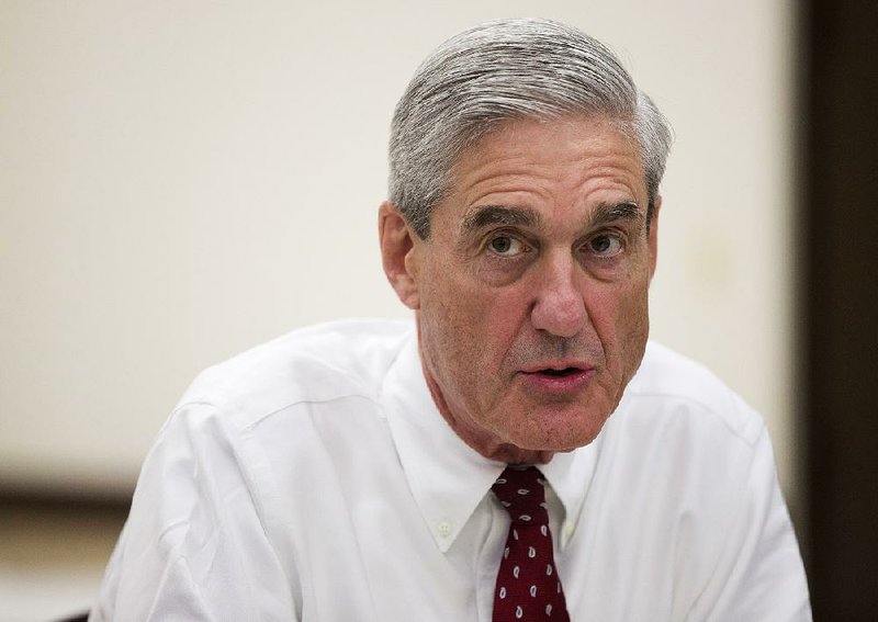 In this Aug. 21, 2013, file photo, then-FBI director Robert Mueller speaks during an interview at FBI headquarters in Washington. 