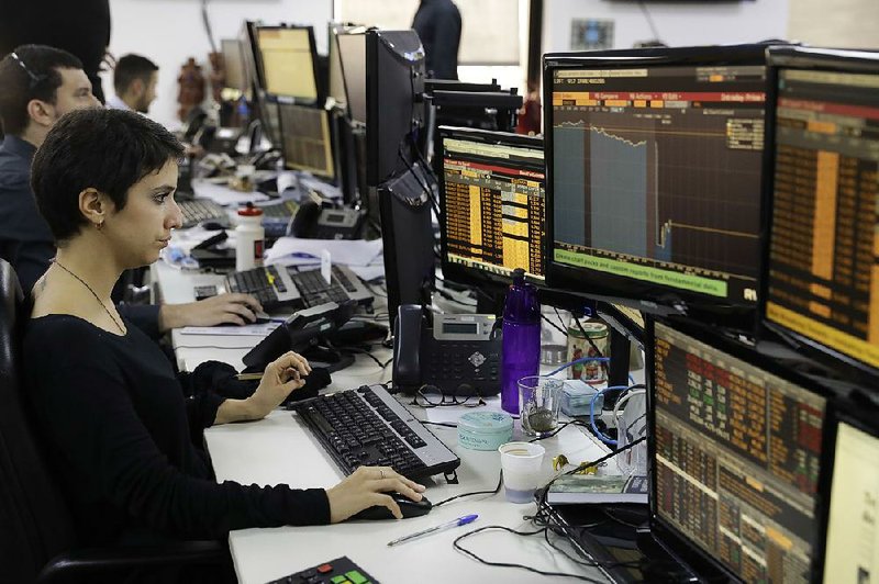 A worker monitors screens at a Sao Paulo brokerage as Brazil’s markets and currency reacted Thursday to the latest scandal surrounding the country’s president.