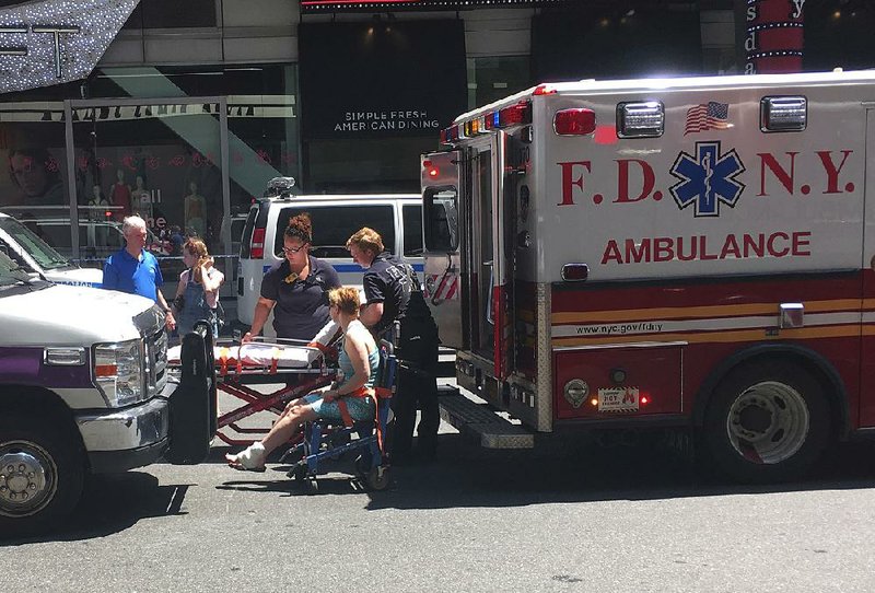 First responders assist one of the victims of a car crash Thursday at Times Square in New York.