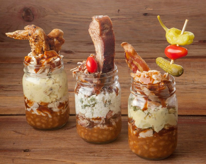 Layers of beans, potatoes, sauce and meat make the Mason jar barbecue “sundaes” an easy-to-carry meal
during Silver Dollar City’s Bluegrass & BBQ Festival.