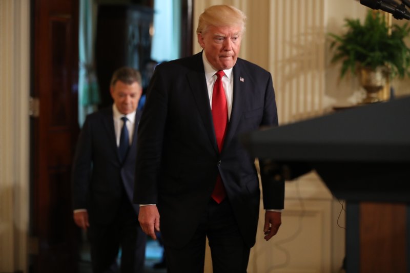 President Donald Trump, followed by Colombian President Juan Manuel Santos arrives for their joint news conference in the East Room of the White House in Washington, Thursday, May, 18, 2017. (AP Photo/Andrew Harnik)