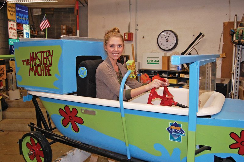 Nikki Haak, the visitor services assistant for Visit Hot Springs, sits in the “The Mystery Machine” tub her team will use in the upcoming Running of The Tubs set for June 3. Haak, the team captain, also came up with the costumes and treats for judges.