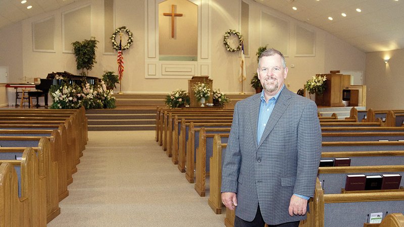 Marty Sikes, pastor of Bono Baptist Church near Greenbrier, stands in the sanctuary. The church will celebrate its 100th anniversary June 4 with dinner on the grounds following the worship services, and Sikes said a bell tower for a church bell that was recovered years ago after being stolen is being erected for the event.