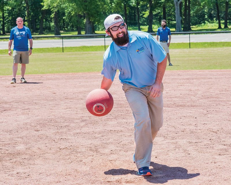 Bryant Parks and Recreation is forming a new adult kickball league with games scheduled to begin in June. Keith Cox, a member of the Bryant Parks and Rec team, pitches to a kicker during a practice at Bishop Park in Bryant. 