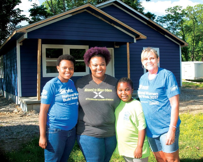From left are Shaniyah Poe, 12; her mom, Shalanda Poe; Shalanda’s youngest daughter, Marshae Poe, 8; and Leigh Anne Hawthorne, affiliate administrator for Habitat for Humanity of White County, standing outside of the home that Habitat for Humanity’s Women Build Week volunteers worked on. Shalanda and her children will live in the home in Searcy upon its completion.
