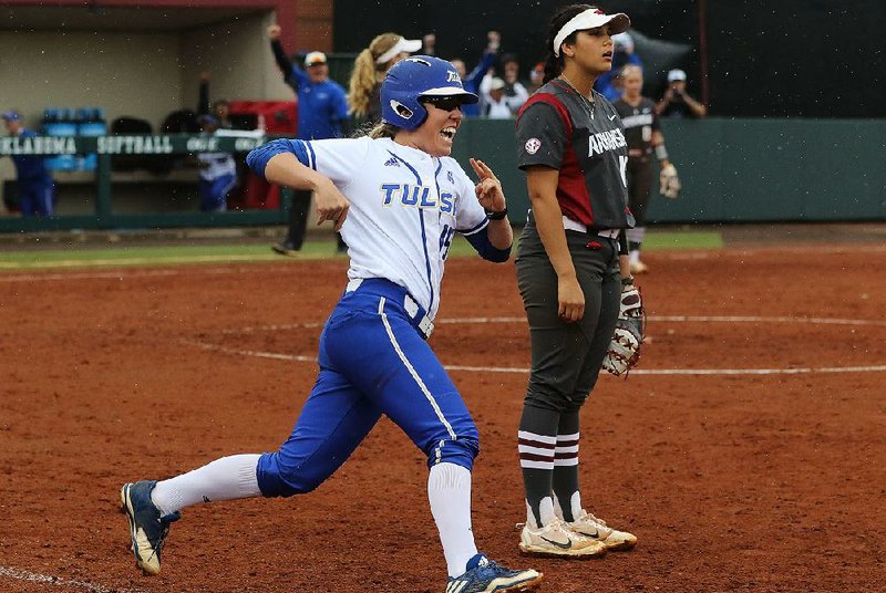Tulsa’s Haley Meinen circles the bases after hitting a leadoff home run in the bottom of the seventh to beat Arkansas 5-4 and drop the Razorbacks to the losers bracket at the NCAA Regional at Norman, Okla., on Friday.