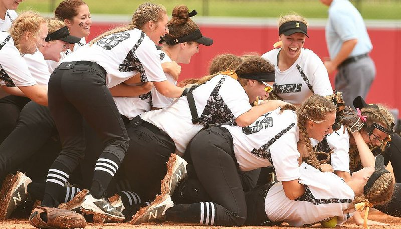 Bentonville celebrates after beating North Little Rock 11-3 on Friday for the Class 7A state softball championship at Bogle Park in Fayetteville. The championship was Bentonville’s second consecutive. 