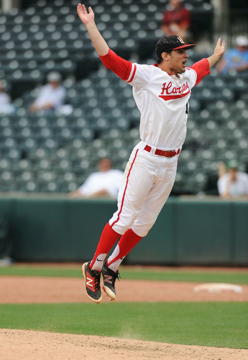 Harding Academy starting pitcher Peydon Harlow leaps with joy after the Wildcats captured the Class 3A state title with a 5-0 victory over Greenland at Baum Stadium on Friday. 