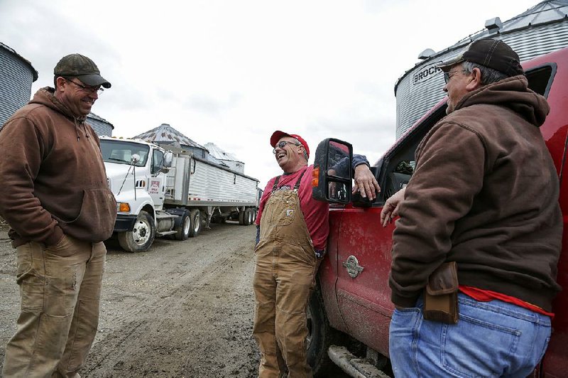 Blake Hurst (center) talks with his brothers, Brooks Hurst (left) and Kevin Hurst, on Blake’s farm last month in Westboro, Mo. Blake Hurst, a corn and soybean farmer and president of the Missouri Farm Bureau, said President Donald Trump’s trade rhetoric “comes up pretty quickly in conversation 