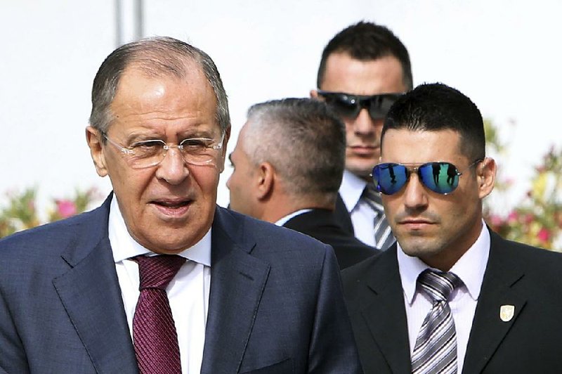 Escorted by security men, Russian Foreign Minister Sergey Lavrov, left, arrives at a session of the Council of Europe's Committee of Ministers at the Filoxenia Conference Center in Nicosia, Cyprus Friday, May 19, 2017. 