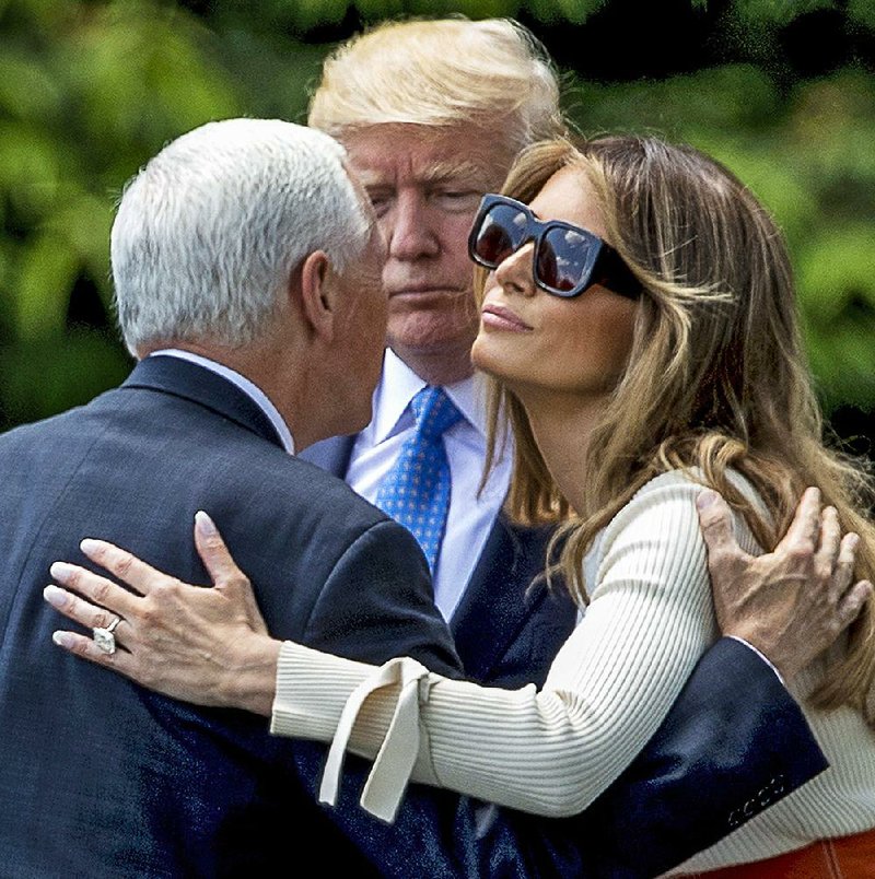 President Donald Trump and first lady Melania Trump say goodbye to Vice President Mike Pence on Friday at the White House before boarding the helicopter Marine One.