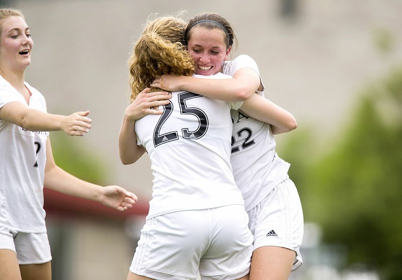 Siloam Springs junior Audrey Maxwell (right) hugs junior Megan Hutto after scoring on an assist from Hutto on Friday against Russellville at Razorback Field in Fayetteville.