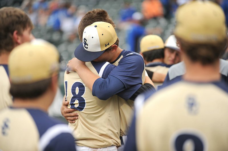 Shiloh Christian players Amos Yarbrough (18) and Connor Clark embrace Friday after falling to Nashville in the Class 4A state championship baseball game at Baum Stadium in Fayetteville. Visit nwadg.com/photos for more photographs from the game.