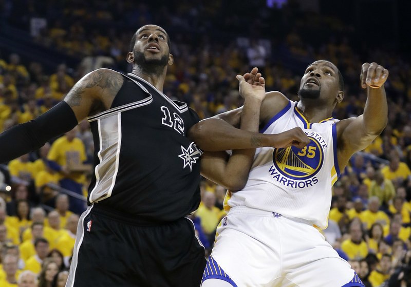 San Antonio Spurs' LaMarcus Aldridge (12) and Golden State Warriors' Kevin Durant (35) work for position under the basket during the second half of Game 2 of the NBA basketball Western Conference finals, Tuesday, May 16, 2017, in Oakland, Calif. (AP Photo/Marcio Jose Sanchez)