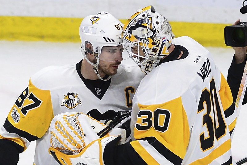 Pittsburgh Penguins center Sidney Crosby (87) celebrates with goalie Matt Murray (30) after the Penguins' 3-2 win over the Ottawa Senators during Game 4 of the NHL hockey Stanley Cup Eastern Conference finals, Friday, May 19, 2017, in Ottawa, Ontario. (Sean Kilpatrick/The Canadian Press via AP)