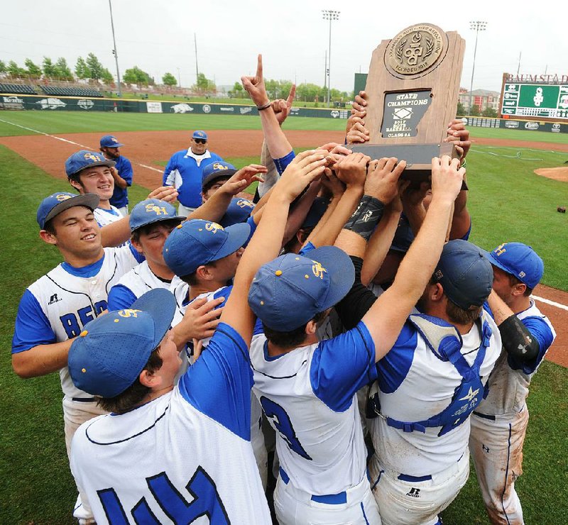 Spring Hill players celebrate a 5-0 victory over Conway St. Joseph to capture the school’s first Class 2A state baseball championship at Baum Stadium in Fayetteville on Saturday.
