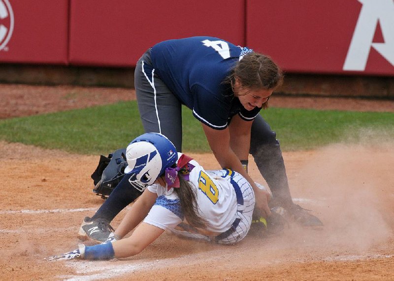 Sheridan’s Nicole Tompkins slides in with the winning run ahead of Greenwood pitcher Kaila Cartwright’s tag in the Lady Yellowjackets’ 3-2 victory Saturday in the Class 6A state softball championship at Bogle Park in Fayetteville.