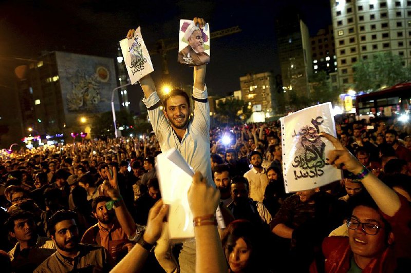 Supporters celebrate Saturday evening in Tehran after Iranian President Hassan Rouhani won re-election over hard-line rival Ebrahim Raisi, who had the backing of the ruling clergy and allied security forces. 