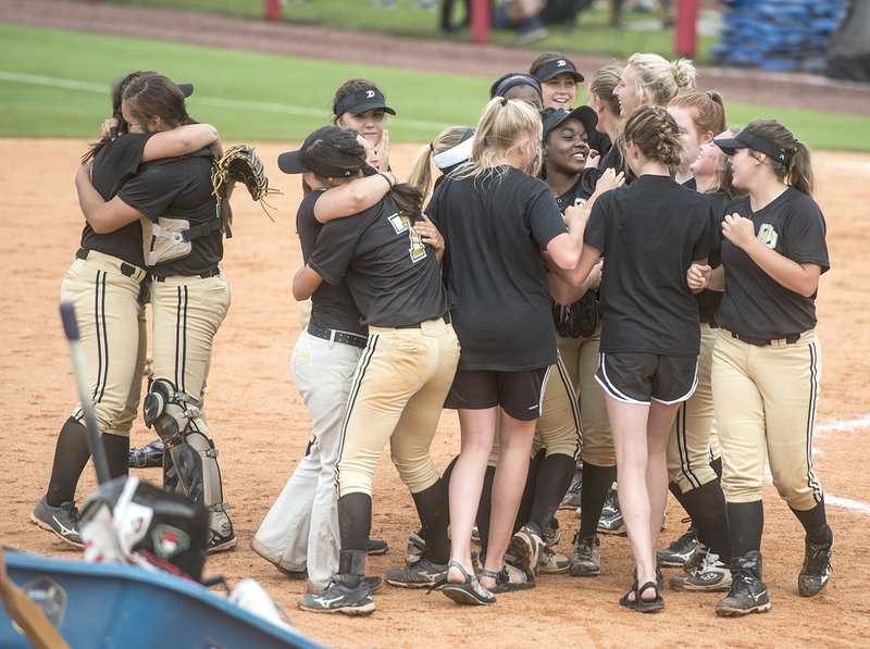 De Queen players celebrate their 4-1 win over Valley View in the 5A state softball championship game Friday at Bogle Park in Fayetteville.