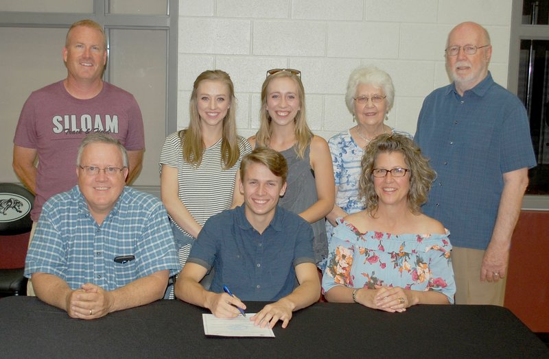 Graham Thomas/Siloam Sunday Siloam Springs senior Chandler Stewart signed a letter of intent Tuesday to run track at the University of the Ozarks in Clarksville. Pictured are: Front from left, father Jeff Stewart, Chandler Stewart, mother Kristin Stewart; back, Siloam Springs boys track coach Chuck Jones, sisters Taylor and Madisen Stewart, and grandparents Lou and Dan Stewart.