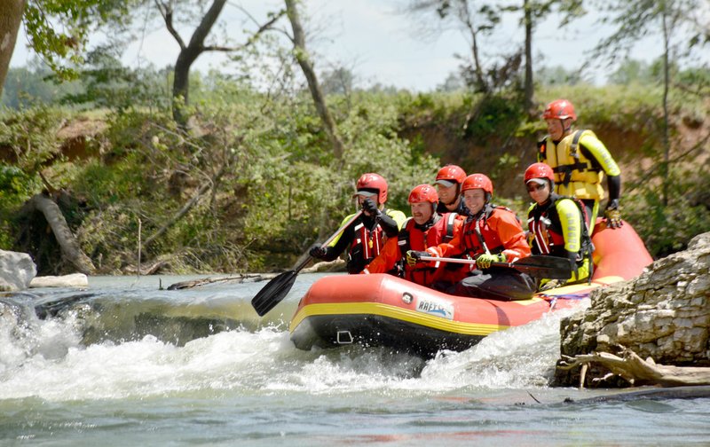 Michael Burchfiel/Siloam Sunday First responders practiced navigating the Siloam Springs Kayak Park using an inflatable raft.