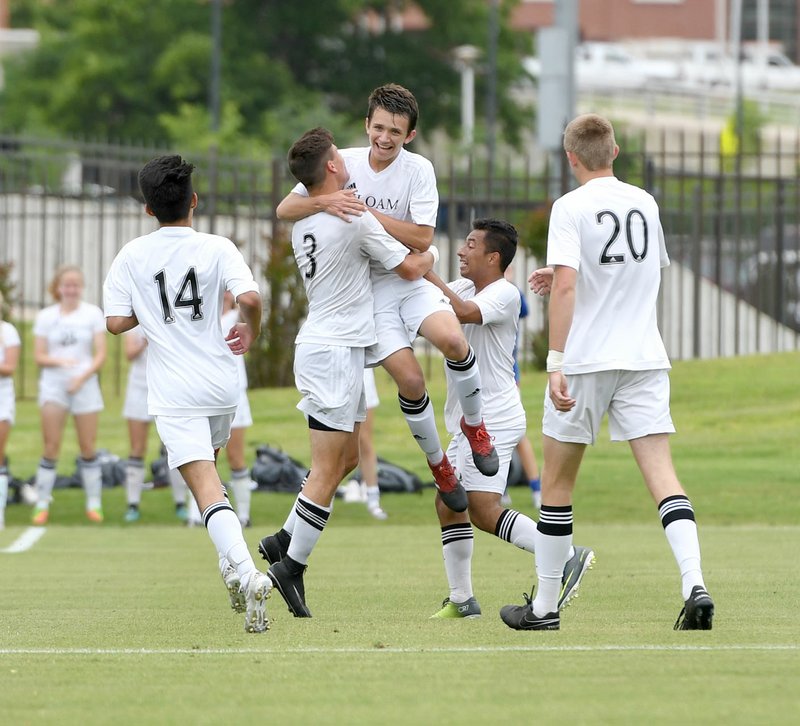 Bud Sullins/Special to Siloam Sunday Siloam Springs senior Austin Shull hoists up sophomore Eli Jackson after Jackson scored the first of three goals on Friday in a 4-0 win against Mountain Home in the Class 6A state championship game.