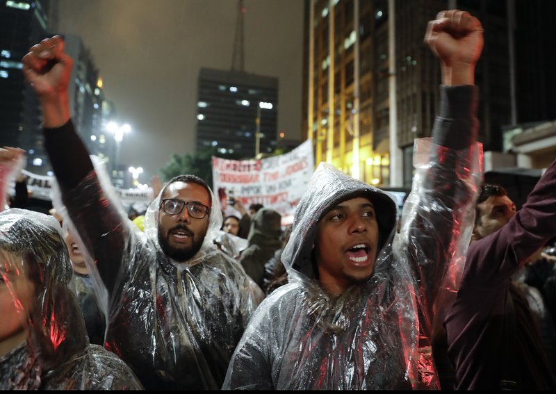 Demonstrators shout slogans against Brazilian President Michel Temer in Sao Paulo, Brazil, Thursday, May 18, 2017. Brazil's political crisis deepened sharply on Thursday with corruption allegations that threatened to topple the president, undermine reforms aimed at pulling the economy from recession and leave Latin America's largest nation rudderless. (AP Photo/Andre Penner)