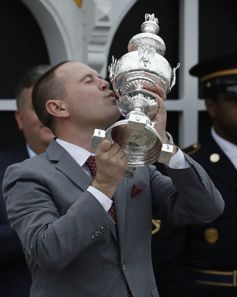 Chad Brown the trainer for Cloud Computing celebrates with the Woodlawn Vase after the horse won the 142nd Preakness Stakes horse race at Pimlico race course, Saturday, May 20, 2017, in Baltimore.
