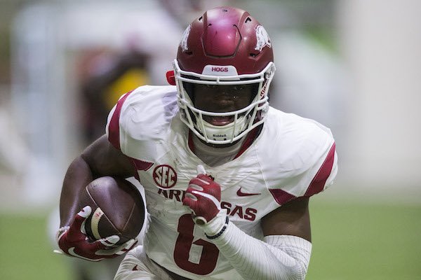 T.J. Hammonds runs after a catch during Arkansas' football practice on Saturday, April 29, 2017, inside Walker Pavilion in Fayetteville.