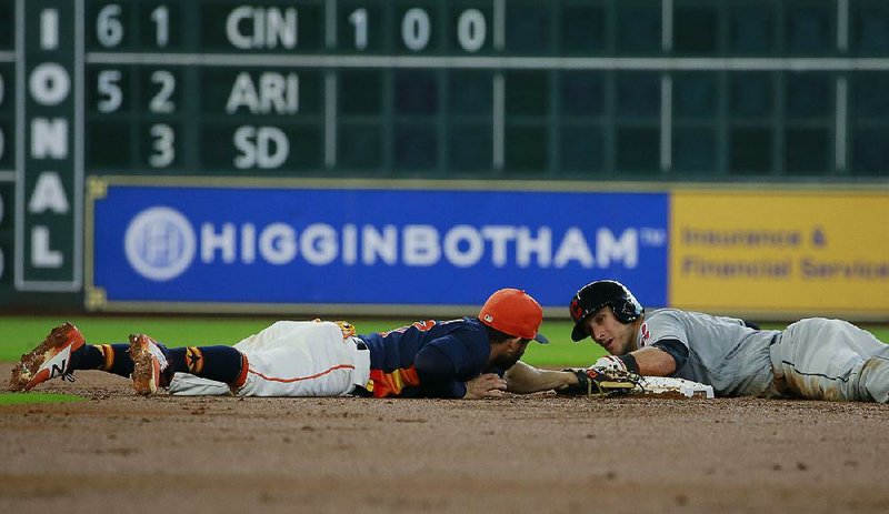 Cleveland catcher Yan Gomes (right) is safe at second base, avoiding the tag of Houston’s Jose Altuve in the second inning of the Indians’ 8-6 victory over the Astros on Sunday at Minute Maid Park in Houston. Gomes added a third-inning home run and drove in five runs as the defending American League champions swept the Astros.