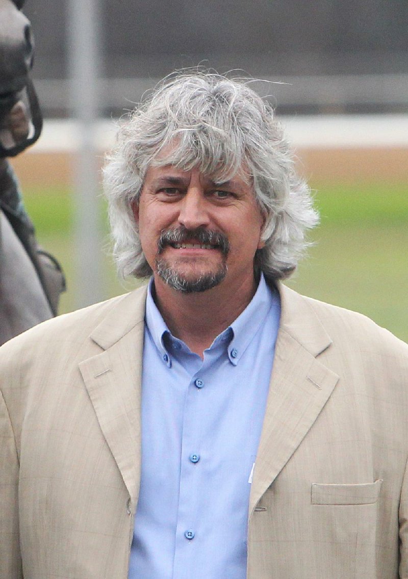 Trainer Steve Asmussen in the winner's circle after his Gun Runner won the Razorback Handicap at Oaklawn Park Monday, February 20, 2017. 