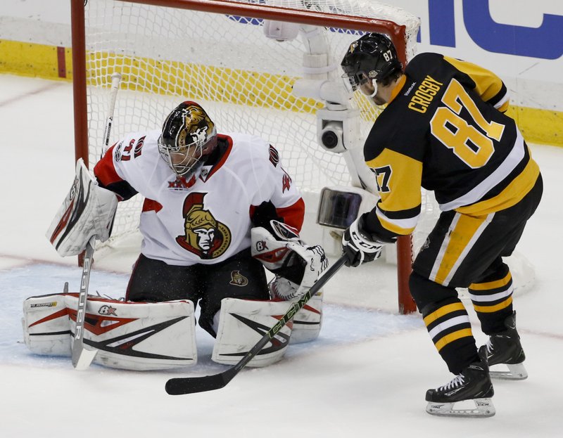 Pittsburgh Penguins' Sidney Crosby (87) scores on Ottawa Senators goalie Craig Anderson (41) during the first period of Game 5 in the NHL hockey Stanley Cup Eastern Conference finals, Sunday, May 21, 2017, in Pittsburgh. 