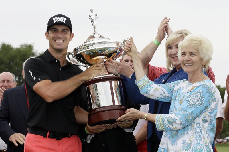 The Associated Press TAKING THE CUP: Billy Horschel is awarded the tournament trophy by Peggy Nelson, widow of Byron Nelson after Horschel's win in the Byron Nelson golf tournament Sunday in Irving, Texas.