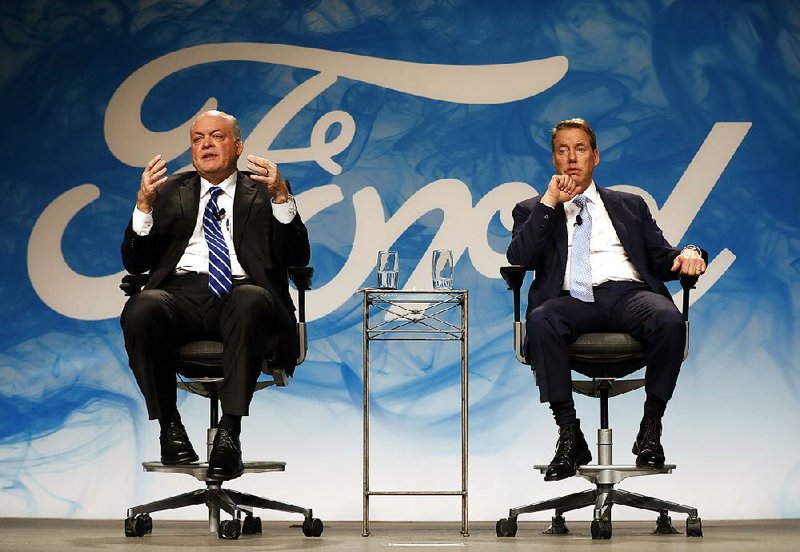 Jim Hackett (left), Ford Motor Co.’s new CEO, speaks at an event with Chairman William Ford Jr. on Monday in Dearborn, Mich.
