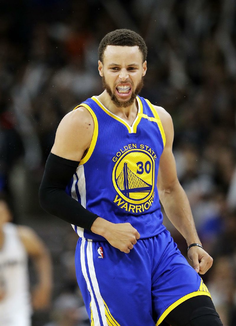 Stephen Curry celebrates during Golden State’s victory over San Antonio in the NBA Western Conference fi nals Monday. Golden State advanced to the NBA Finals for the third consecutive year.