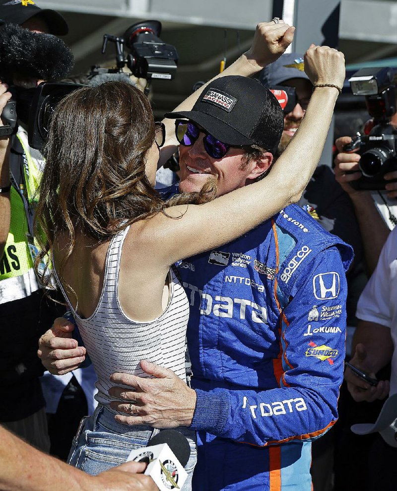 Scott Dixon celebrates with his wife, Emma, after winning the pole for Sunday’s Indianapolis 500. A few hours
later, Dixon was robbed at gunpoint by two teenagers at a nearby Taco Bell.