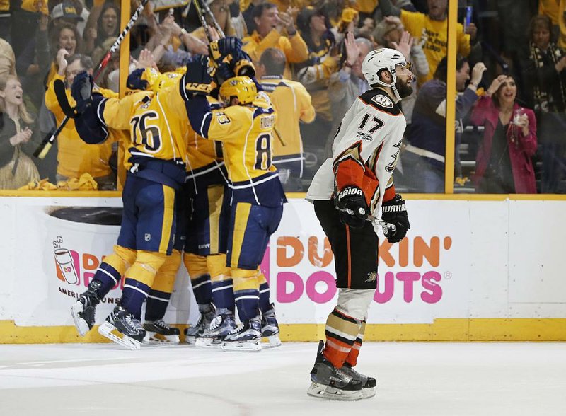 Anaheim Ducks center Ryan Kesler skates past as Nashville Predators players celebrate an empty-net goal in the third period of Game 6 of the NHL Western Conference finals Monday night. Nashville won 6-3 to clinch the series and advance to the Stanley Cup Final.
