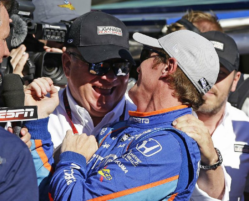 Indianapolis 500 pole-sitter Scott Dixon (right) accepts congratulations from car owner Chip Ganassi after Dixon finished the 2.5-mile course in 2 minutes, 35.0630 seconds, edging Ed Carpenter for the inside spot on the fi rst row.