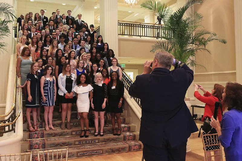 Some of the Little Rock School District’s top seniors pose for a group photo Monday afternoon at the Governor’s Mansion before the start of an event to honor them.
