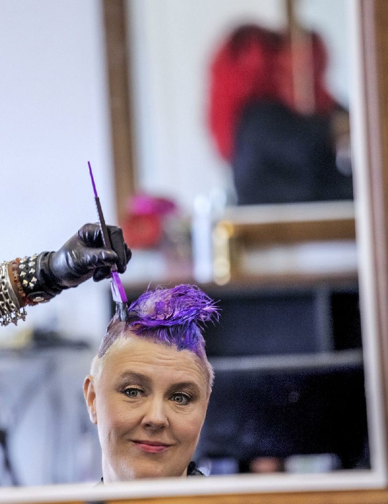 Hairdresser Stacie Mack uses the free-hand technique to do a color treatment on Andi Stracner, 44, of North Little Rock, who has worn bold, attention-getting colors for years. The trend is likened to tattoos in that it’s no longer favored just by rebels and eccentrics.