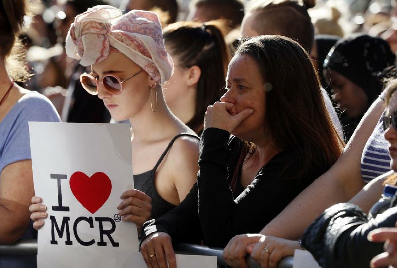 Mourners attend a vigil Tuesday in Manchester, England, for the victims of Monday’s attack.