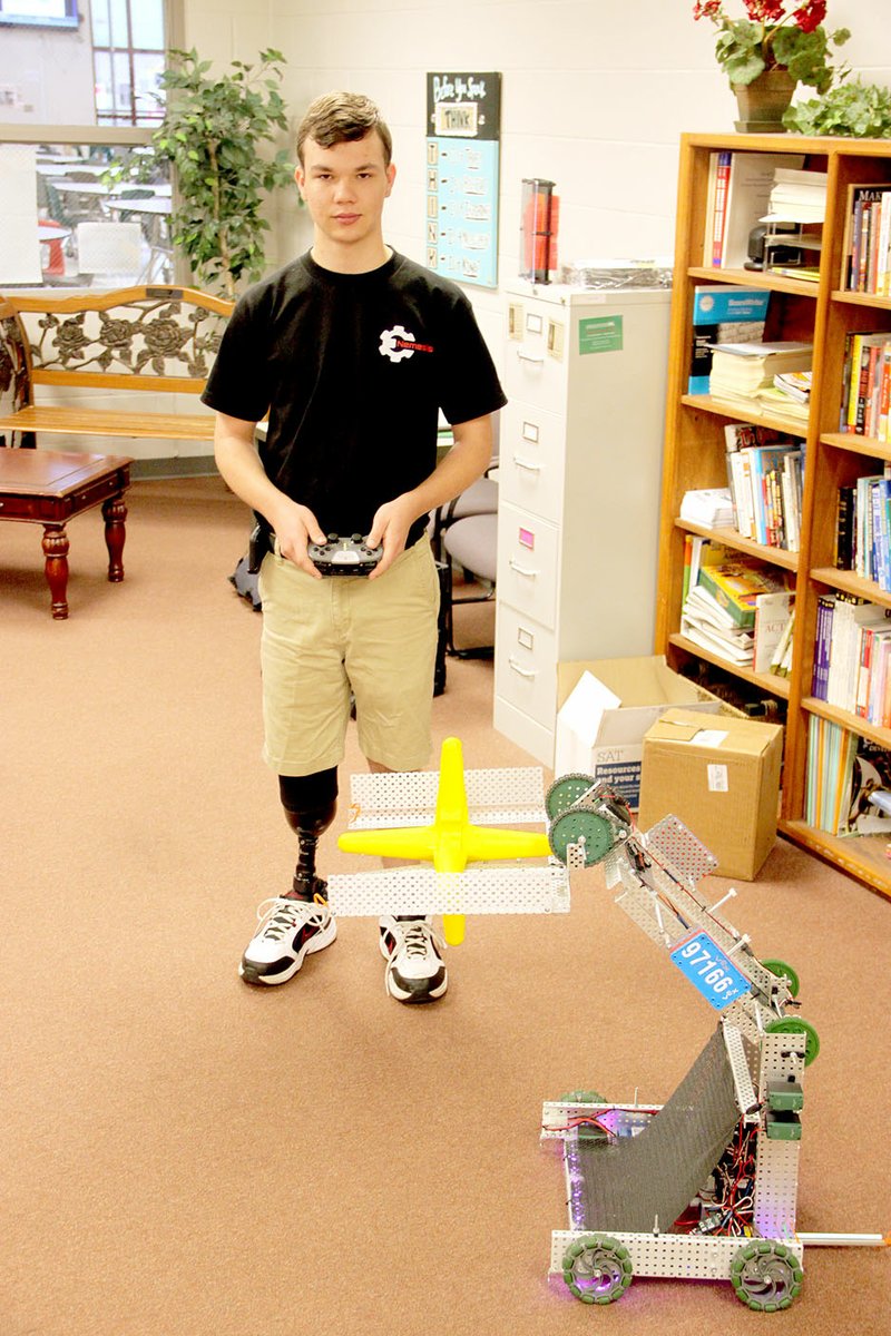 LYNN KUTTER ENTERPRISE-LEADER Remington Haingaertner, a Farmington High School junior, participated in the Vex Robotics World Competition in April with this robot he named after his friend Grant White. Remington and Grant were riding a moped on Wedington Drive when it was struck by a vehicle that failed to stop. White died from injuries received in the accident and Remington lost his foot and part of his leg.