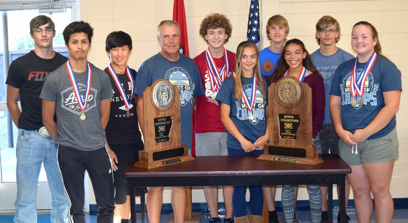 Photo by Mike Eckels Members of the 2017 Decatur High School boys&#8217; and girls&#8217; track teams took a few minutes to show off their medals and trophies during the May 15 Decatur School Board meeting in the Media Center at Decatur Middle School. Winning 10 state championships during the 1A meet were team members Cayden Bingham (left), Jimmy Mendoza, Leng Lee, Coach Shane Holland, Ryan Shaffer, Destiny Meija, Bracy Owens, Desi Meek, Taylor Haisman and Cameron Shaffer.
