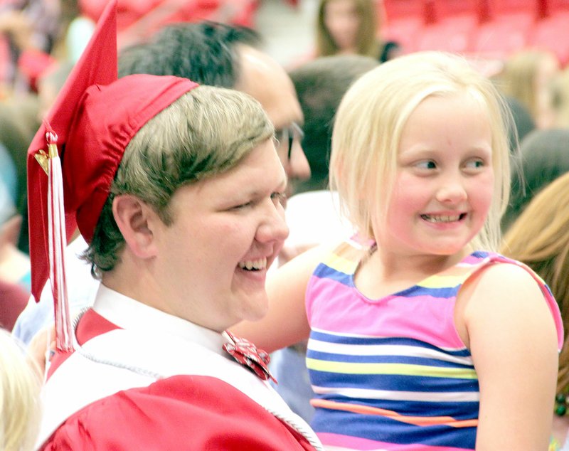 PHOTOS BY LYNN KUTTER ENTERPRISE-LEADER Christopher Danenhauer poses for a photo with his cousin, Ella West, of Bella Vista. Danenhauer was one of 170 seniors to graduate from Farmington High School on May 16.
